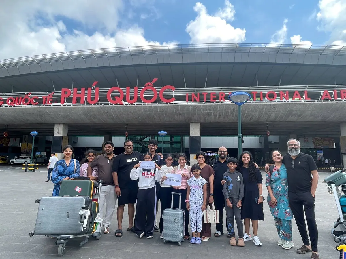 A Fiesta Asia Travel group with their luggage outside Phu Quoc International Airport, waiting for the coach transfer
