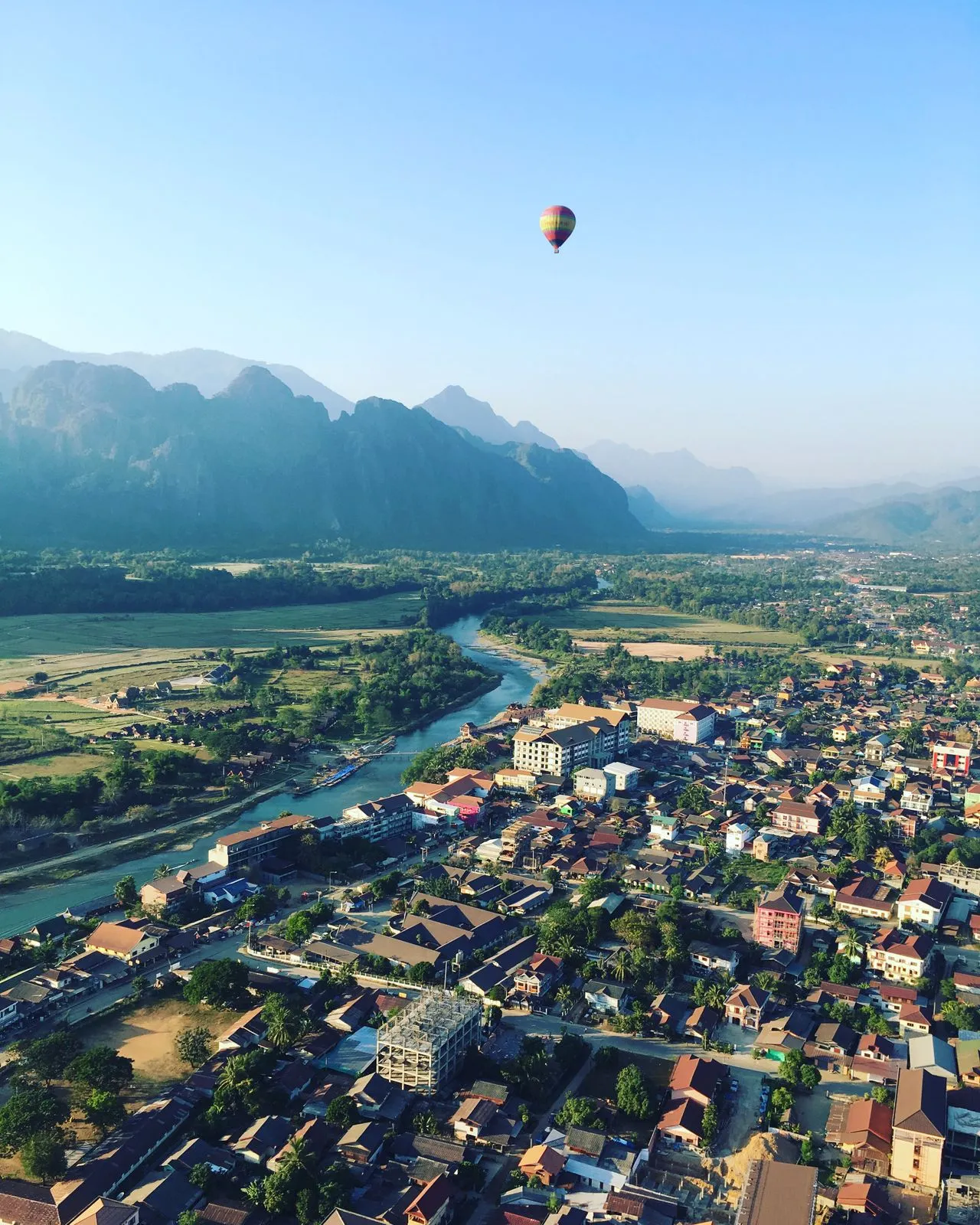 A hot air balloon over the Nam Song river and karst mountains, Vang Vieng, Laos
