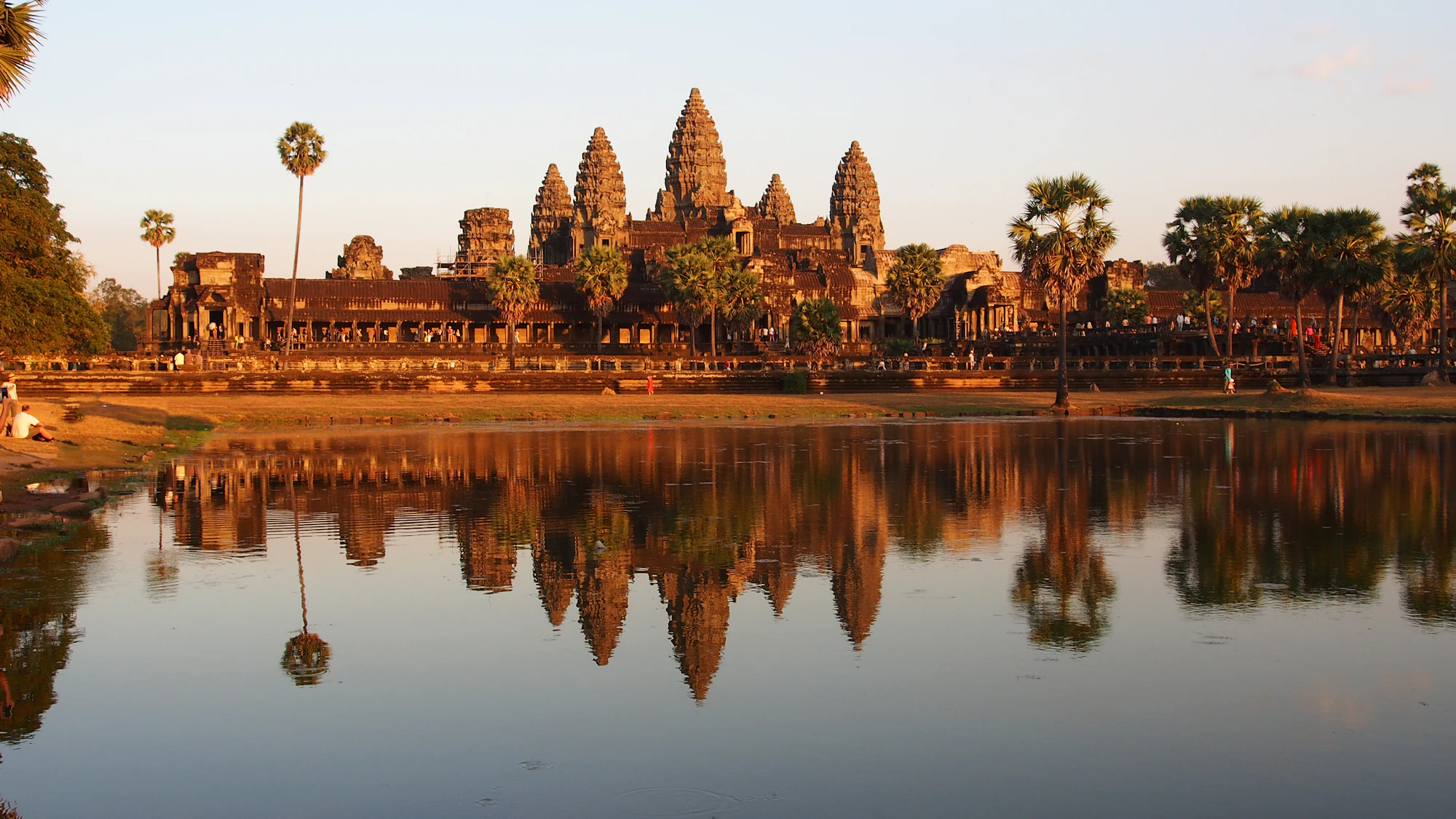 The towers of Angkor Wat reflected in water at golden hour, Cambodia DMC by Fiesta Asia Travel